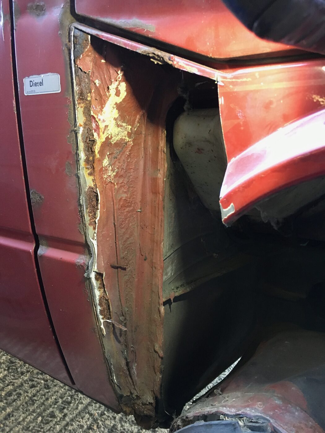 Larger section of corroded metal cut out from the wheel arch, showing rust depth