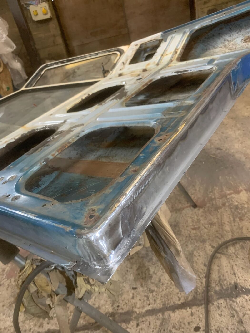 Bodywork mid-restoration — bare metal and patch panels